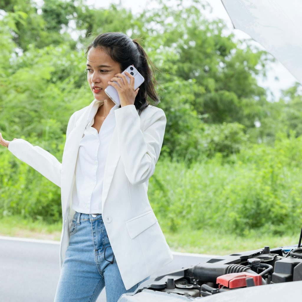 oman calling help and insurance auto service with a problem broken car on the road, angry upset